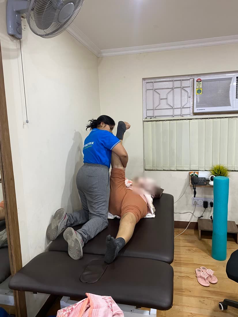 Female physiotherapist performing a supervised stretch on a patient at Physiotrix Ballygunge