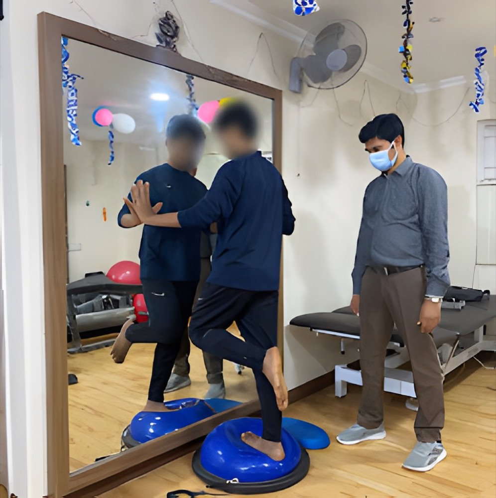 Patient doing balance training on a wobble cushion with a physiotherapist during recovery